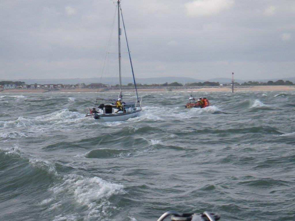 Voluntary Worker following Hayling Lifeboat towing Pupsick
